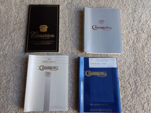 Lot of  4 cadillac cimarron owners manuals unused coupons 1982 86 - 88 pristine