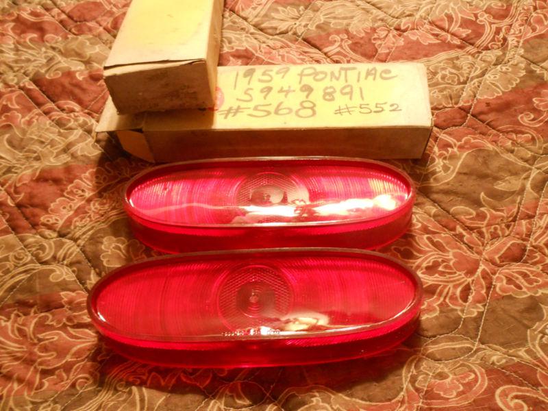 Nos pair 1959 pontiac tail light lens.  