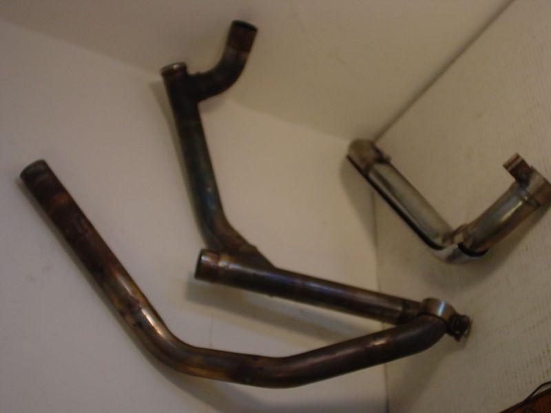 Stock exhaust pipe set from a 2000 harley roadking motorcycle crossover & covers