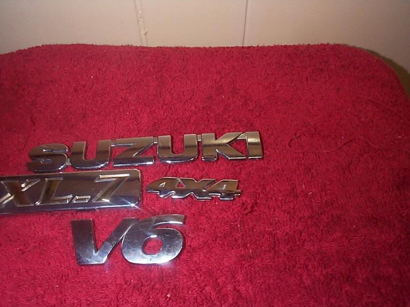 1 used 4 pcs suzuki xl-7,v6,4x4,emblems set