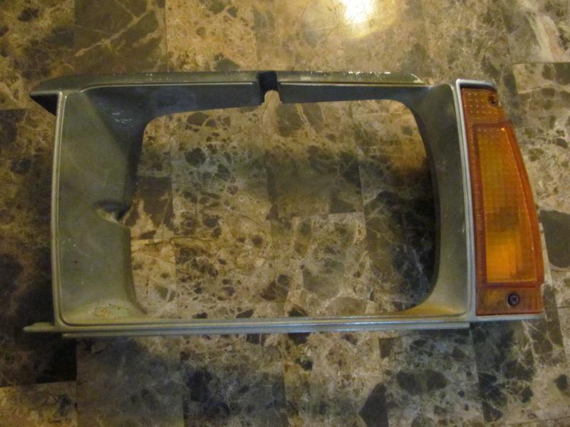 1980 toyota corolla wagon chrome right headlight trim and corner light assembly.