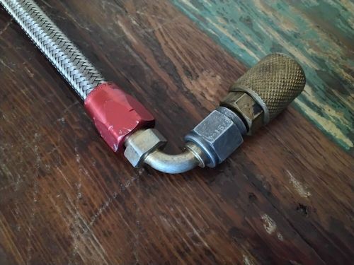 Stainless steel braided hose with attachments pre-owned without box