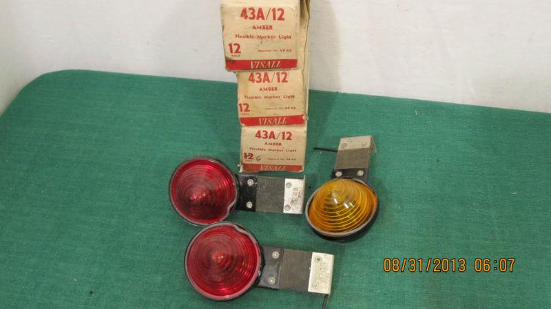 Three vintage flexible marker lights two red, one amber