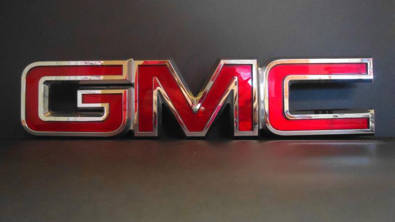 Big used genuine "gmc" nameplate fits grille 13 7/16" x 3" reflective red/chrome