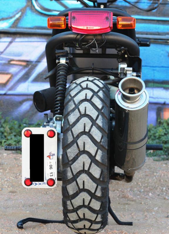 Gloss black honda ruckus tail light and turn signal relocation bracket  