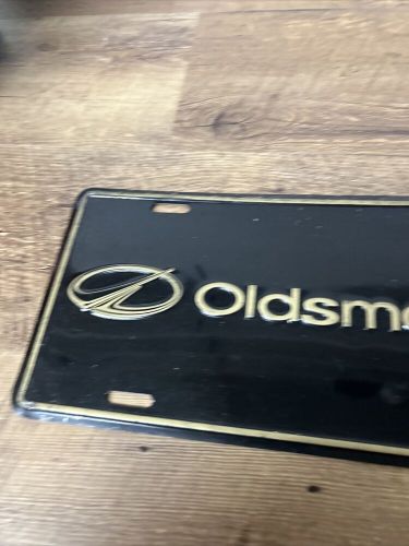 Oldsmobile  gold an black  license plate  new