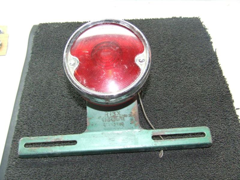 Vintage guidcolite r-13x tail light with swing-up licenese plate bracket