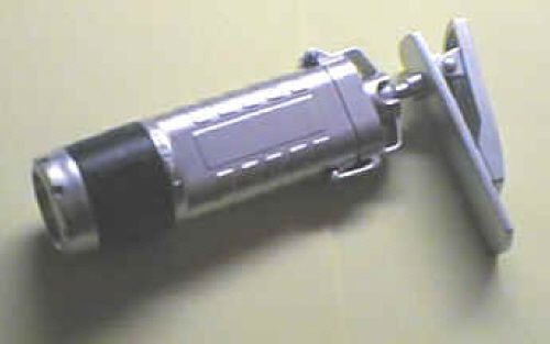 Flashlight with swivel clamp on fixture