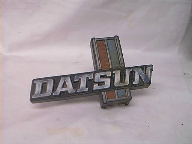 Datsun 620 factory oem grille emblem with mounting clip nice! used