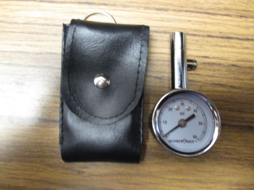 Mini chrome dial tire gauge with case.