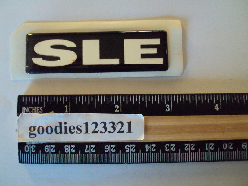 Sle black and silver plastic emblem #15001730 used 3" x 1"