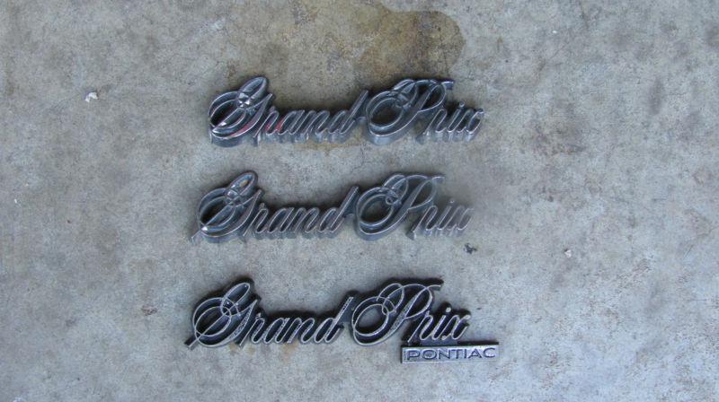 1985-1987 pontiac grand prix emblem set oem badges x3 fenders + trunk lid 85 86 