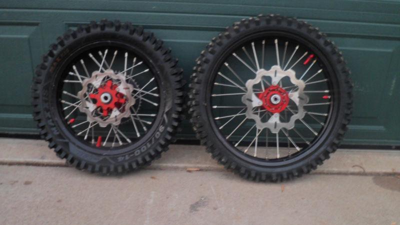 Black honda cr85 rims with red hubs and tires