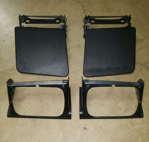 84-88 pontiac fiero head light lid covers doors w/ bezels surround left right