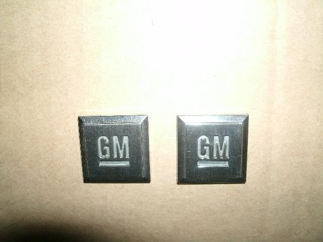 Two gm mark of exellence emblems - pair of gm badges - gm memorabila