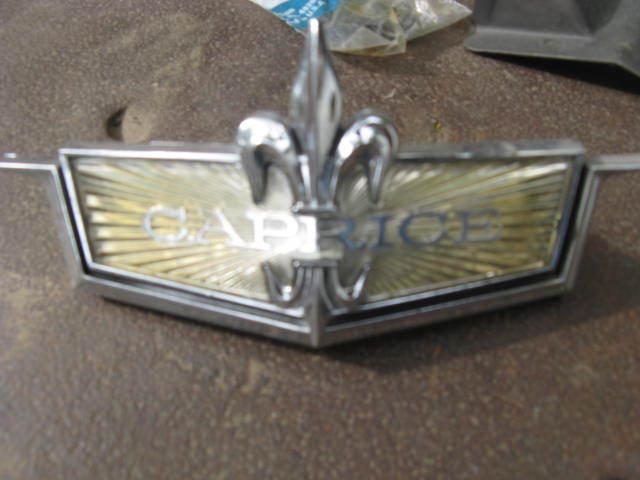 1971 chevrolet caprice nos header panel emblem, in the gm box, complete