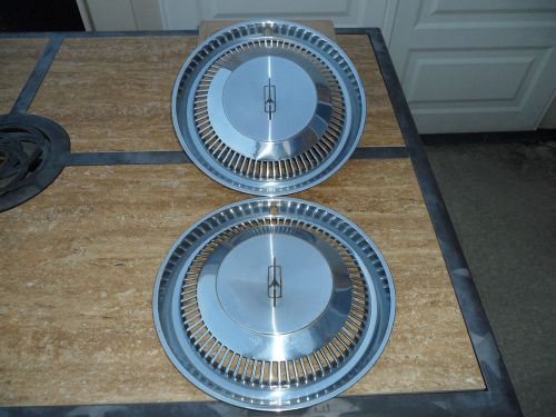 A pair of 14 inch oldsmobile hubcaps