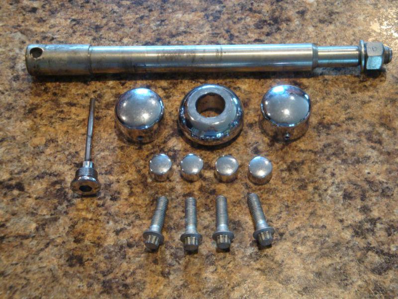 Harley davidson rear axle with parts and hardware.