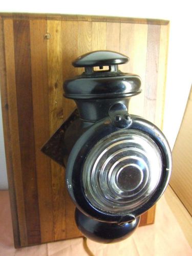 Antique ford model t side light,  electrified and mounted on a plate wood