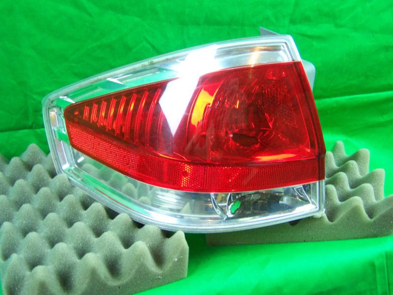 Used 2008 ford focus oem left side tail light with chrome bezel / driver side