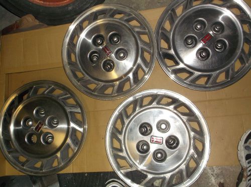 Set of 4 oldsmobile cutlass ciera hubcaps with most chrome color lug nuts