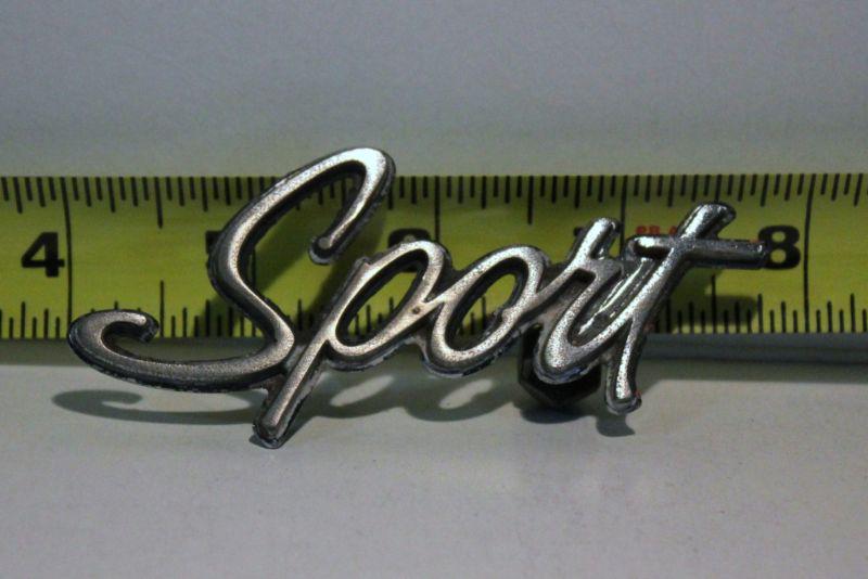 Old car emblem sport removed from junked car many years ago