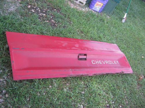 Used vintage red chevrolet tailgate god for decor