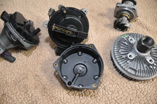 Lot of water pumps, distributers caps engine cooling fan clutch.