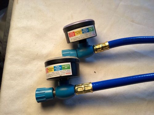 Two removable refrigerant level gauge assemblies