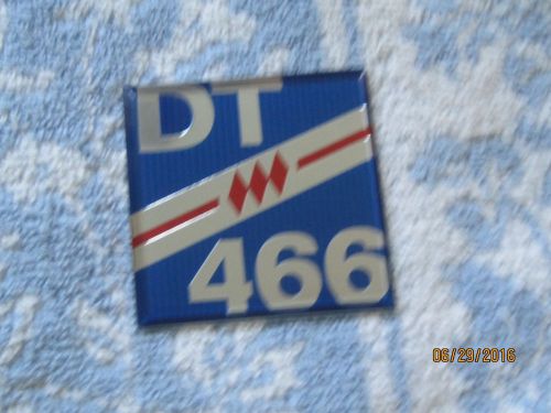 Nos 1970s-1980s? dt 466 plastic stick on emblem; measures 2 1/4 inches wide.