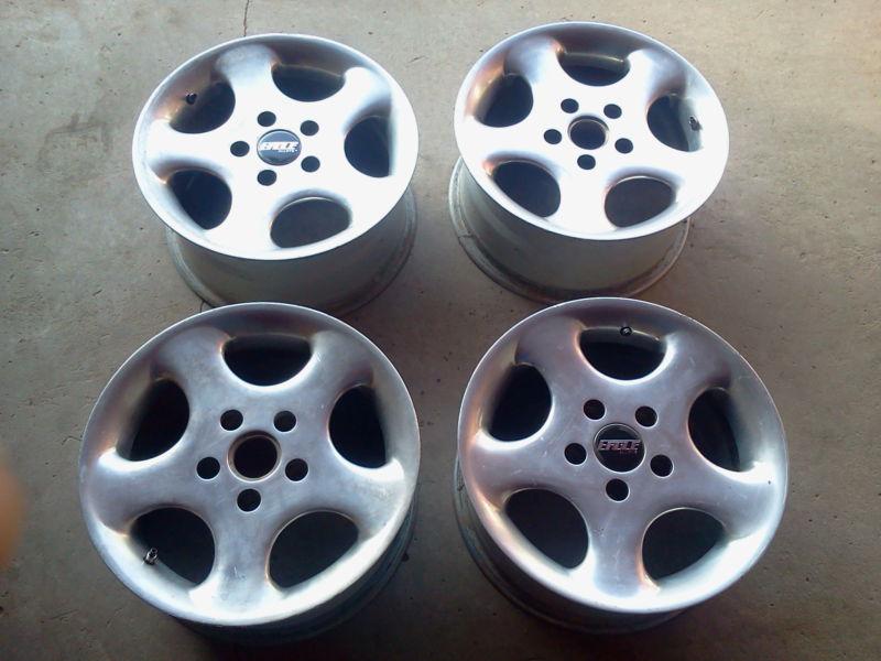 * four 15" alloy rims / 115mm / fits most gm & chrysler front wheel drive models