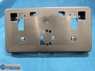 Mazda 3 sedan 2007-2009 new oem front bumper license plate holder