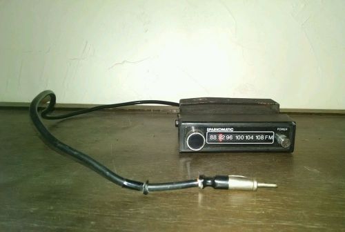 Vintage sparkomatic fm radio converter with mounting bracket.