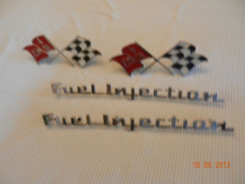 1957  chevrolet  fuel  injection  &  crossed  flags  emblem  n.o.s. with  boxes