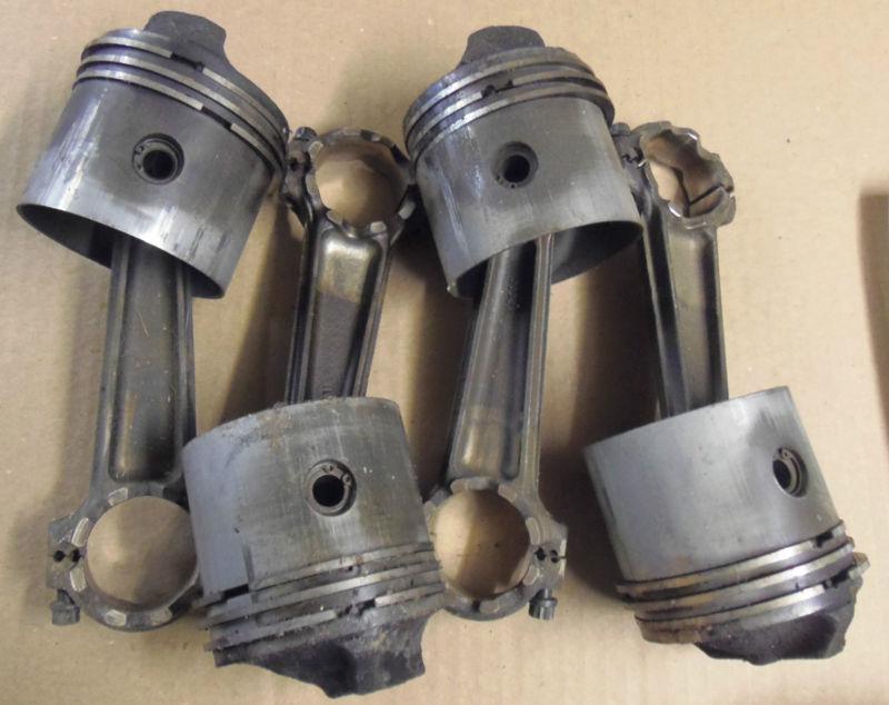 Set of 4 pistons p# 311748 and rods p# 308251 from a 1960's johnson/evinrude v4