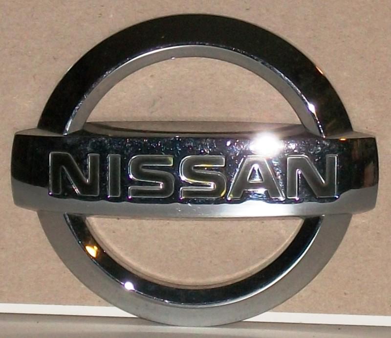 Nissan emblem chrome plastic measures 4_1/8" wide x 3_1/2" high