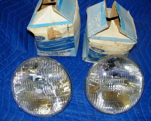 1955 ford nos pair of 6 volt ford script, sealed beam headlights original pkg.