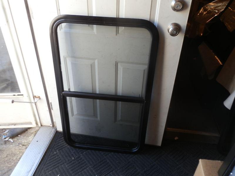 Rv black tinted up & down window r.o. 40" x 24" ( used )