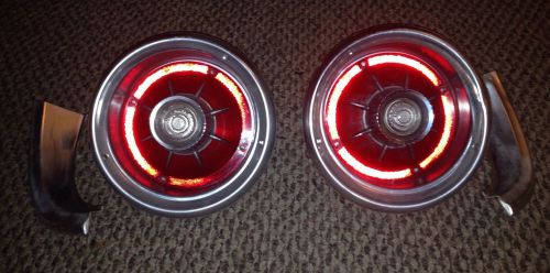 Oem 1964 ford galaxie rear tail lights with bezels and molding. wiring good