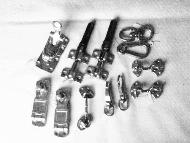 An assortment of  new and used  hooks and latches