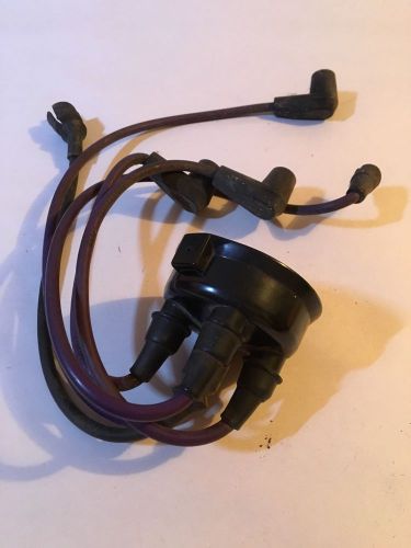 Triumph spitfire distributor cap with spark plug wires.