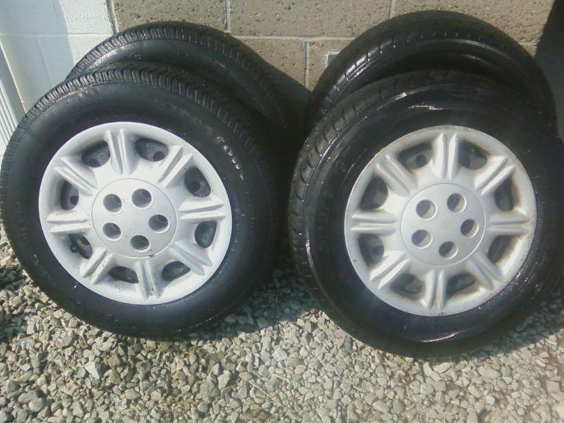 (4) used 205 65 15 tires and 15"rims for sable/taurus/etc..