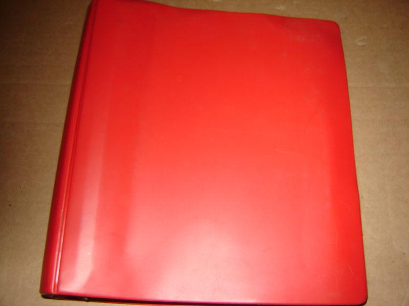 Red binder full of gm chevrolet service training instrutions & operating info