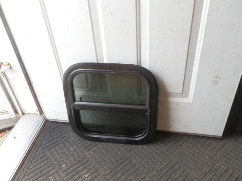 Rv black tinted up & down window r.o. 15" x 15"  ( used )