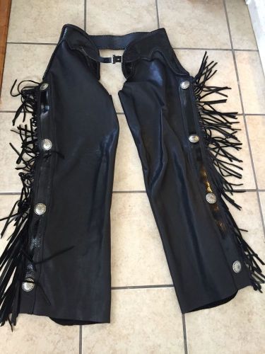 Fringed leather chaps with conchos