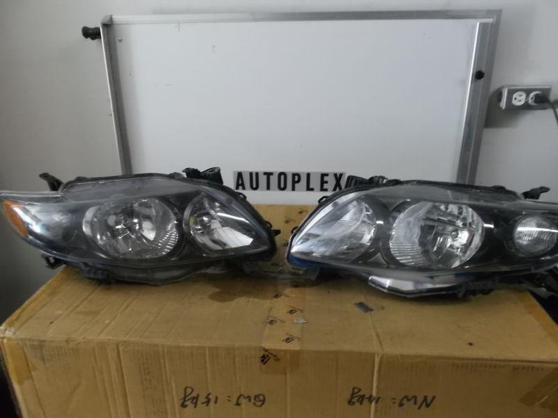  2009  2010 toyota corolla black bezel headlight set oem driver  passenger side 