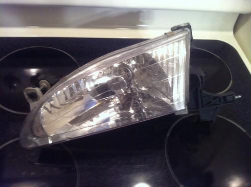 1999  toyota headlight left oem corola 98-00