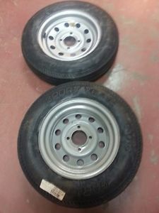 Two 530x12 load range c carlisle boat trailer tires on used 4 hole wheels