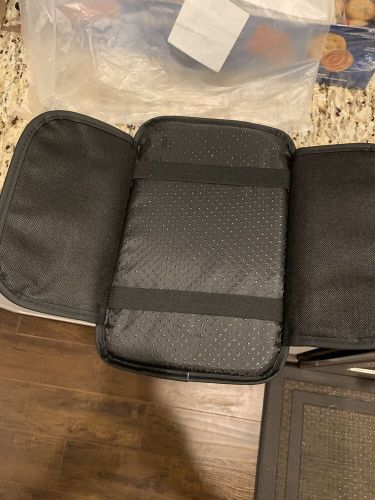 Black quilted car armrest cover in excellent condition.