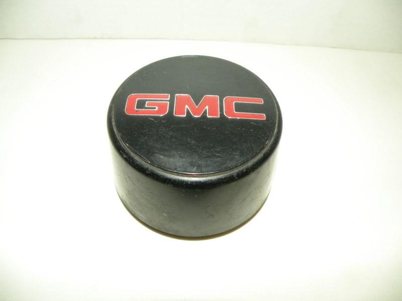 Gmc center cap,  black plastic with red letters  oem